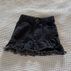 Distressed black denim skirt